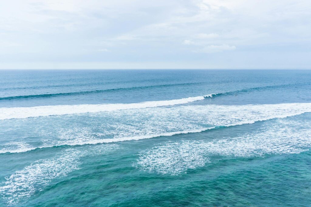 Tranquil seascape of Kuta Selatan in Bali with gentle waves and turquoise waters.